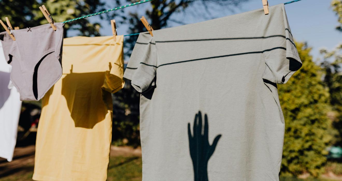 Clothes drying on rope with clothespins in garden