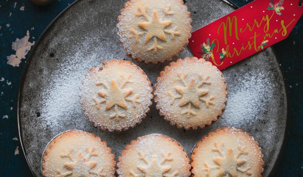 mince pies on a plate with a red merry Christmas tag