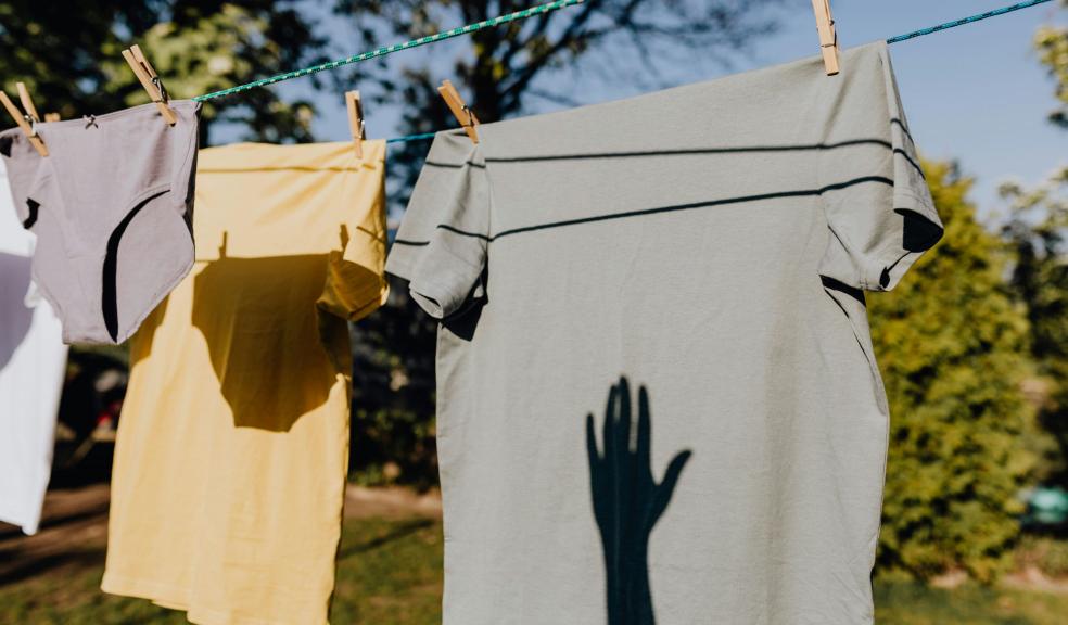 Clothes drying on rope with clothespins in garden