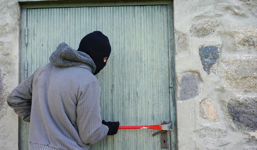 A burglar breaking into a house