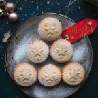 mince pies on a plate with a red merry Christmas tag