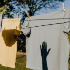 Clothes drying on rope with clothespins in garden
