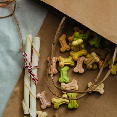 dog biscuits and munchie bones in a brown paper bag