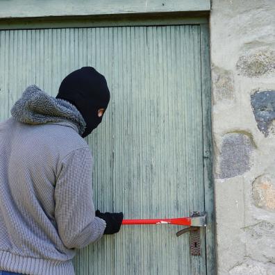 A burglar breaking into a house